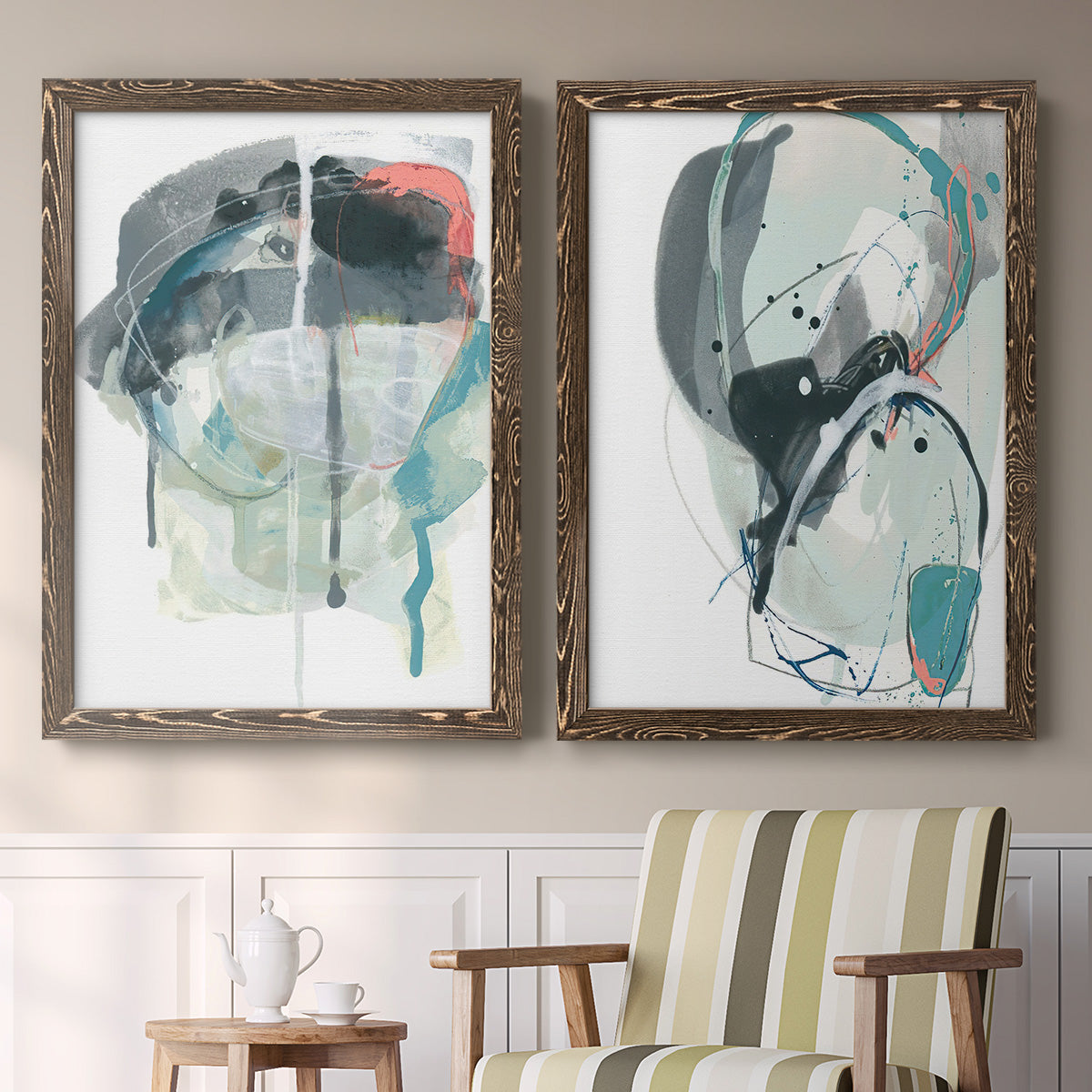 Set of two walnut barnwood framed canvas prints depicting two bold gestural abstracts featuring large black gray and teal circular gestures above a sideboard in a cozy sitting room.