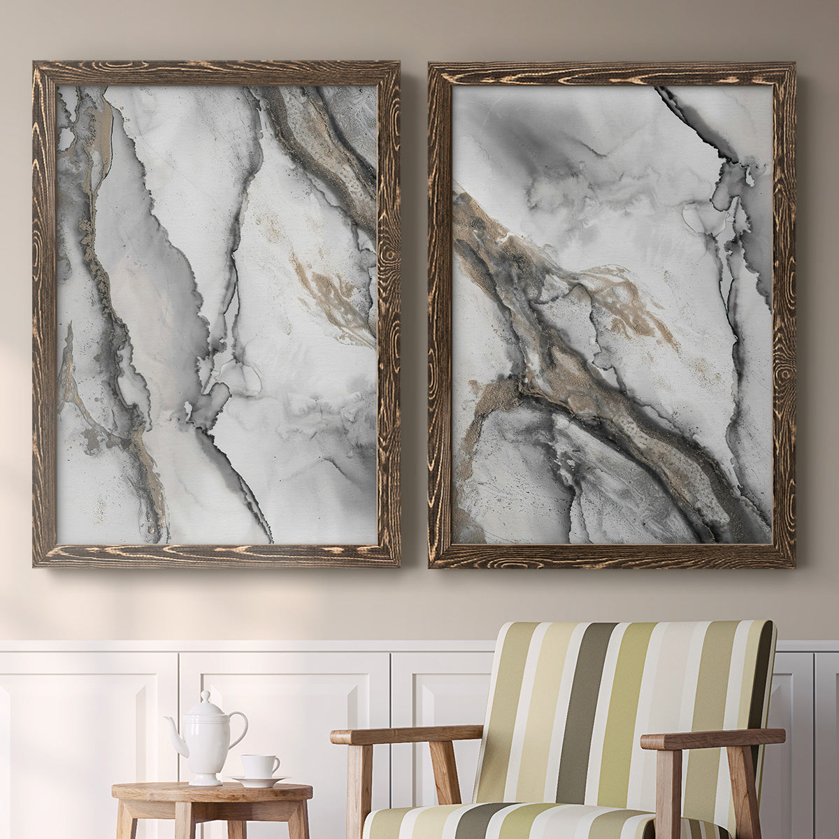 Set of two walnut barnwood framed canvas prints depicting two marbled alcohol ink abstracts with flowing black gray white and metallic gold veining above a sideboard in a cozy sitting room.
