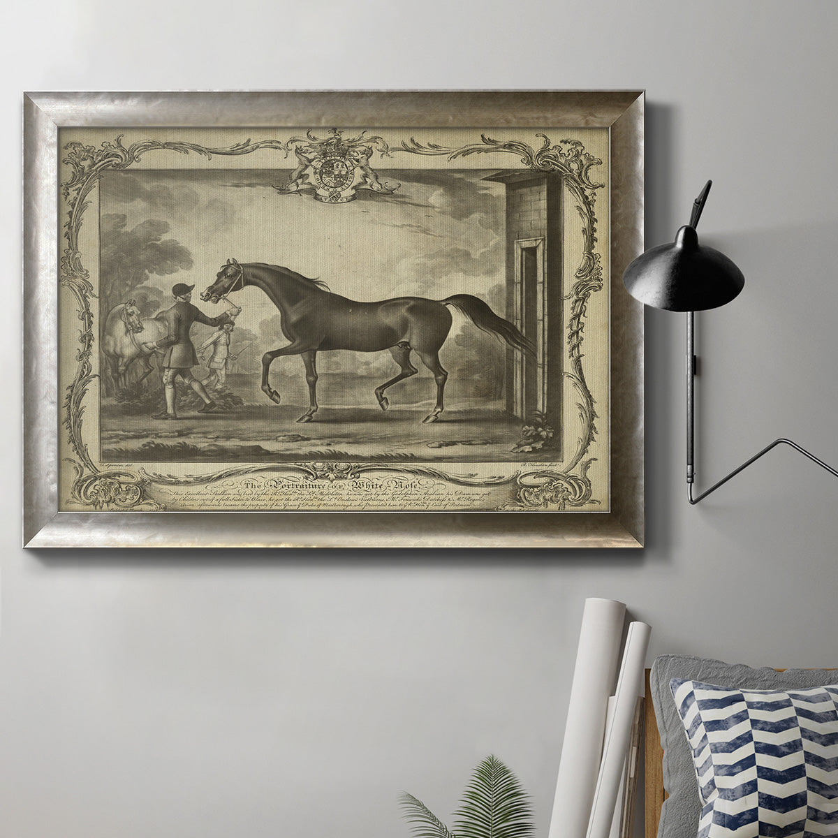 Antique horse illustration in a countryside setting in an ornate mottled silver frame displayed in a neutral interior setting.