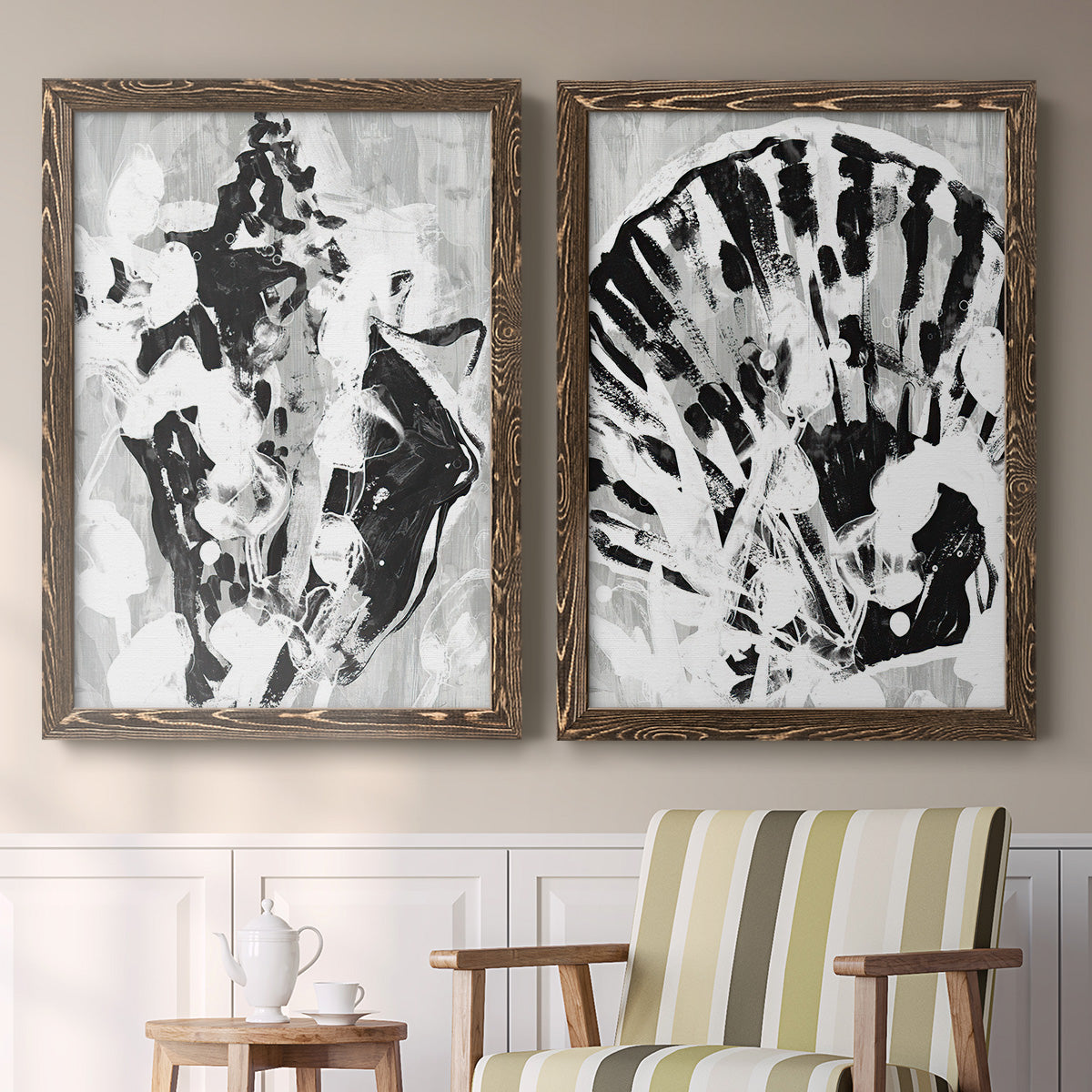Set of two walnut barnwood framed canvas prints depicting two dramatic monochrome abstracts featuring black and gray inkblot bursts above a sideboard in a cozy sitting room.
