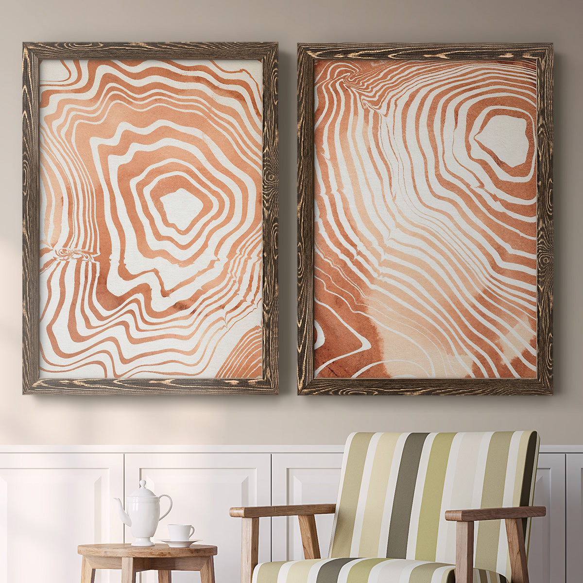 Set of two walnut barnwood framed canvas prints depicting two minimalist marbled pattern abstracts featuring concentric wood-grain rings and rippling contour lines above a sideboard in a cozy sitting room.