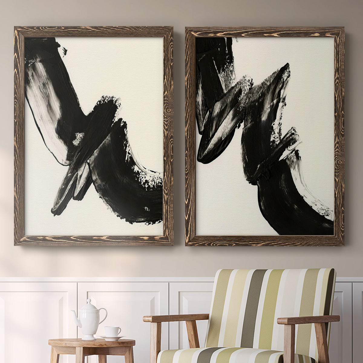 Set of two walnut barnwood framed canvas prints depicting two bold gestural abstracts featuring sweeping black calligraphic brushstrokes above a sideboard in a cozy sitting room.