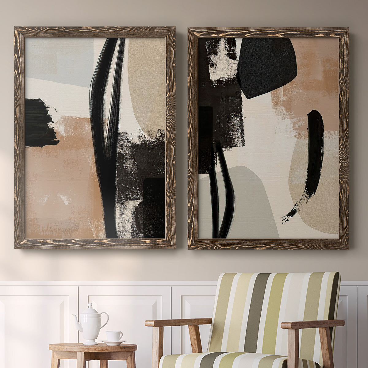 Set of two walnut barnwood framed canvas prints depicting two minimalist collage-like abstracts featuring black taupe cream and beige painted forms above a sideboard in a cozy sitting room.