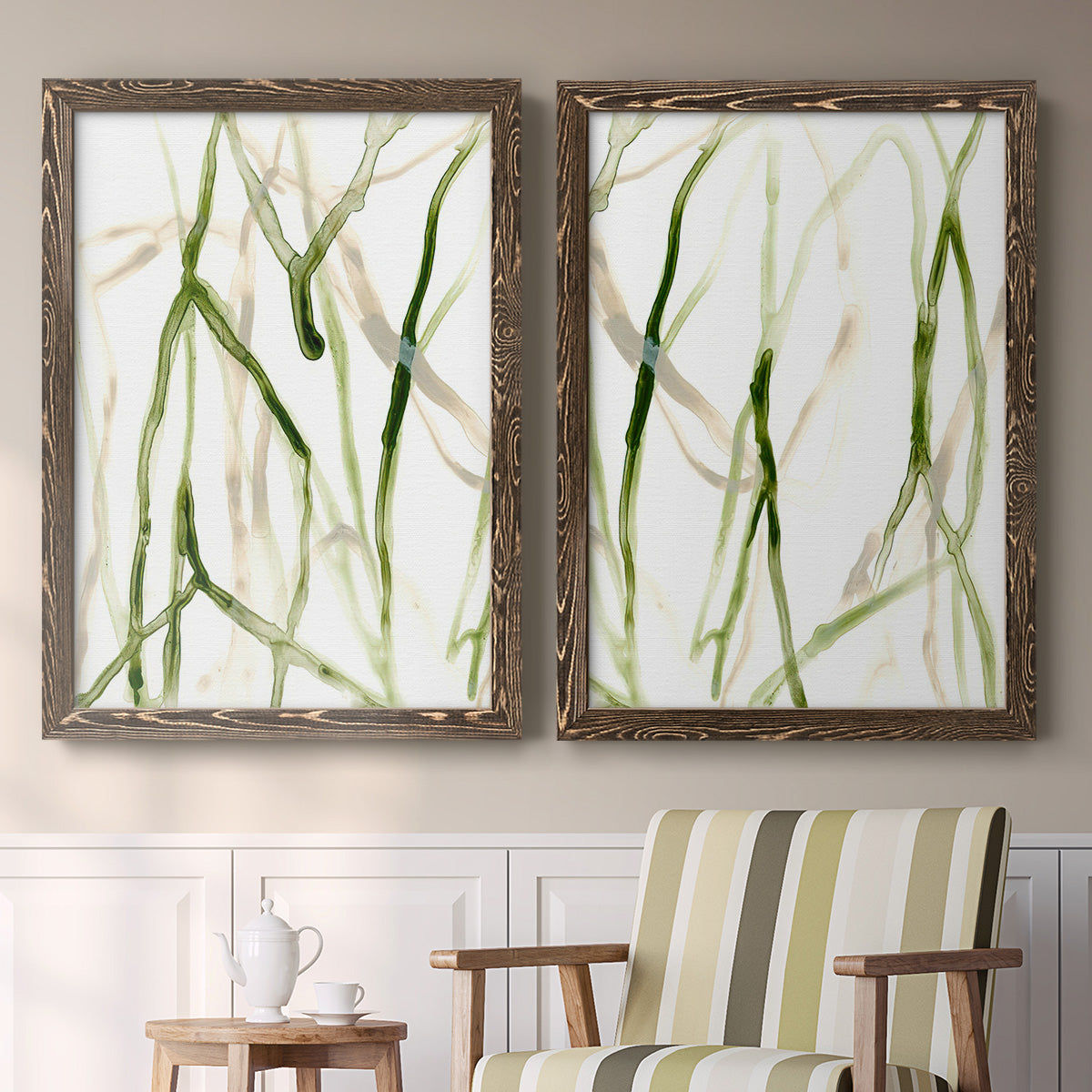 Set of two walnut barnwood framed canvas prints depicting two fluid organic abstracts featuring branching watercolor lines drifting across white above a sideboard in a cozy sitting room.