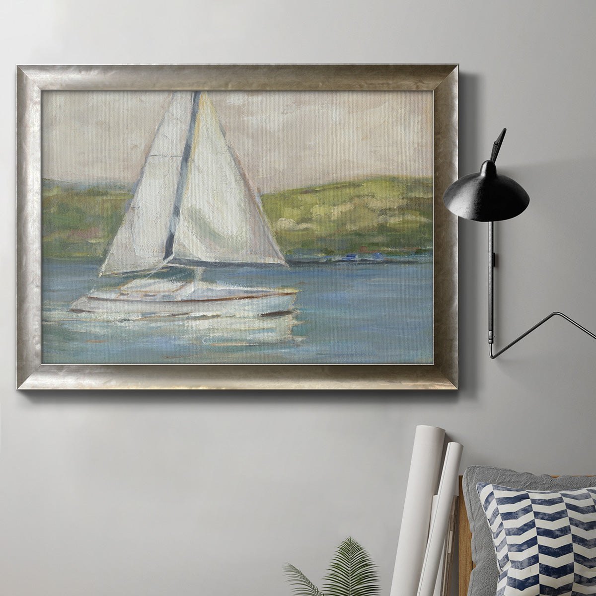 Classic coastal sailboat seascape artwork in an ornate mottled silver frame displayed in a neutral interior setting.