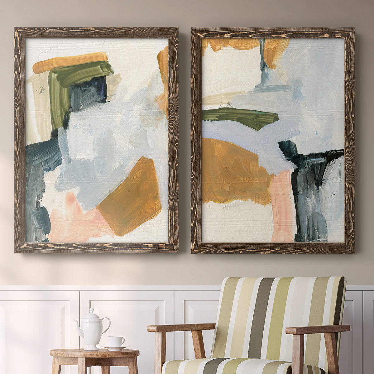Set of two walnut barnwood framed canvas prints depicting two contemporary mixed-media abstracts featuring layered green ochre blush gray and white paint blocks above a sideboard in a cozy sitting room.