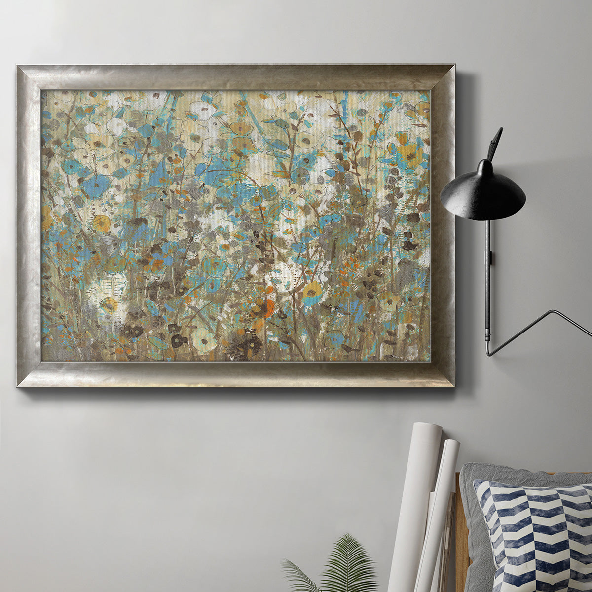 French country floral vine watercolor painting in an ornate mottled silver frame displayed in a neutral interior setting.