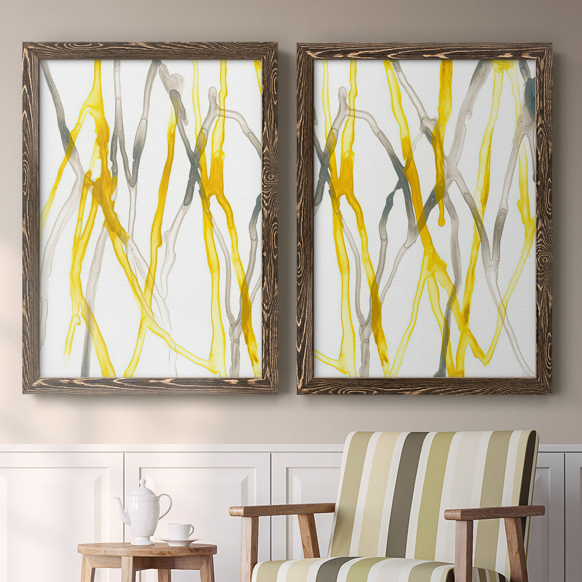 Set of two walnut barnwood framed canvas prints depicting two fluid organic abstracts featuring branching watercolor lines drifting across white above a sideboard in a cozy sitting room.