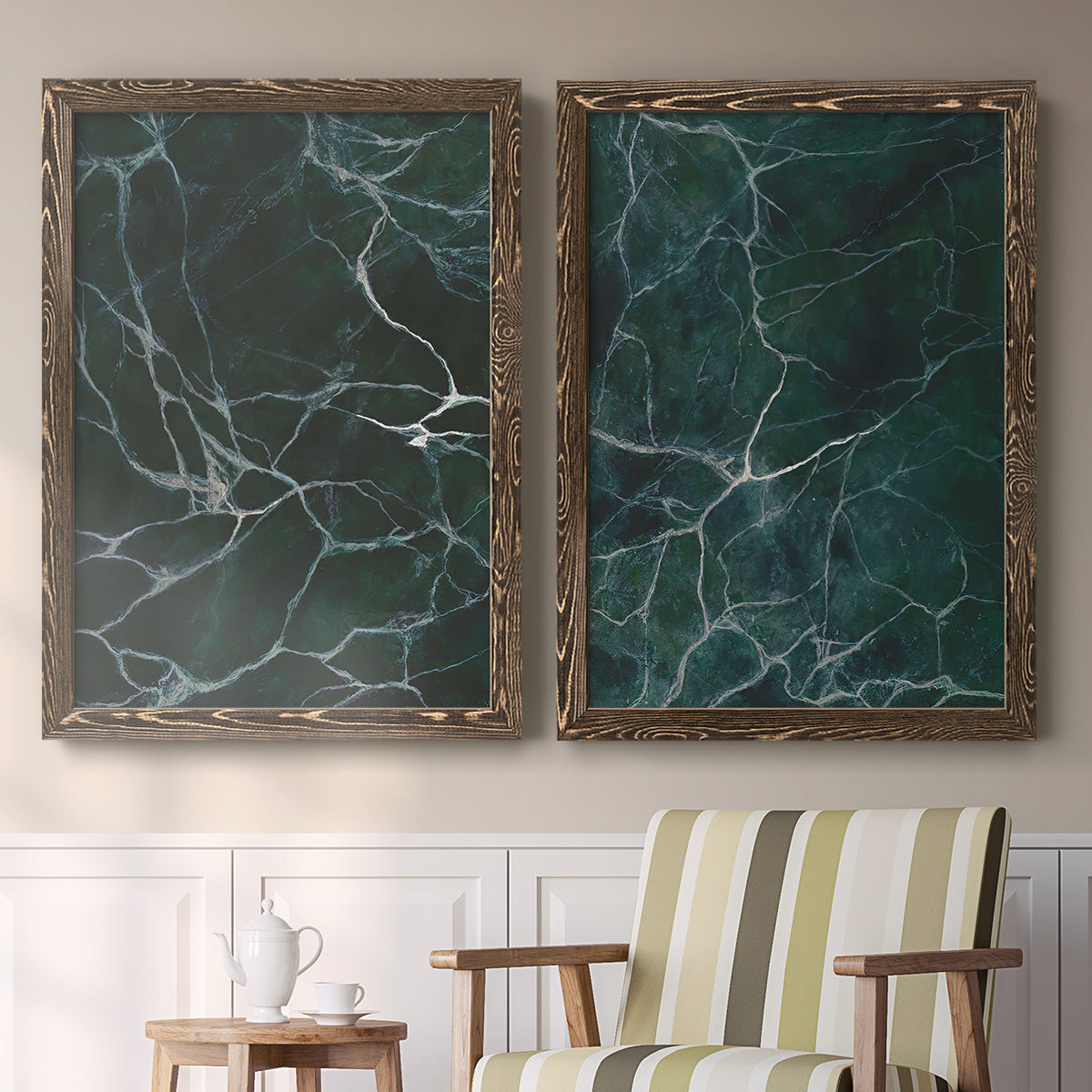 Set of two walnut barnwood framed canvas prints depicting two dramatic stone-inspired abstracts featuring dark green marble veining above a sideboard in a cozy sitting room.