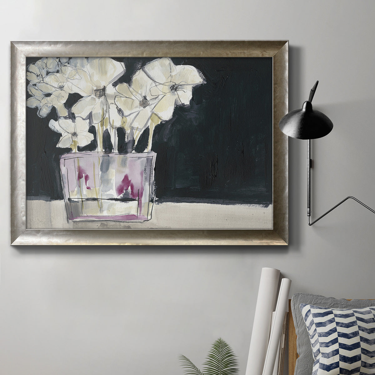 Contemporary floral watercolor with white flowers in an ornate mottled silver frame displayed in a neutral interior setting.