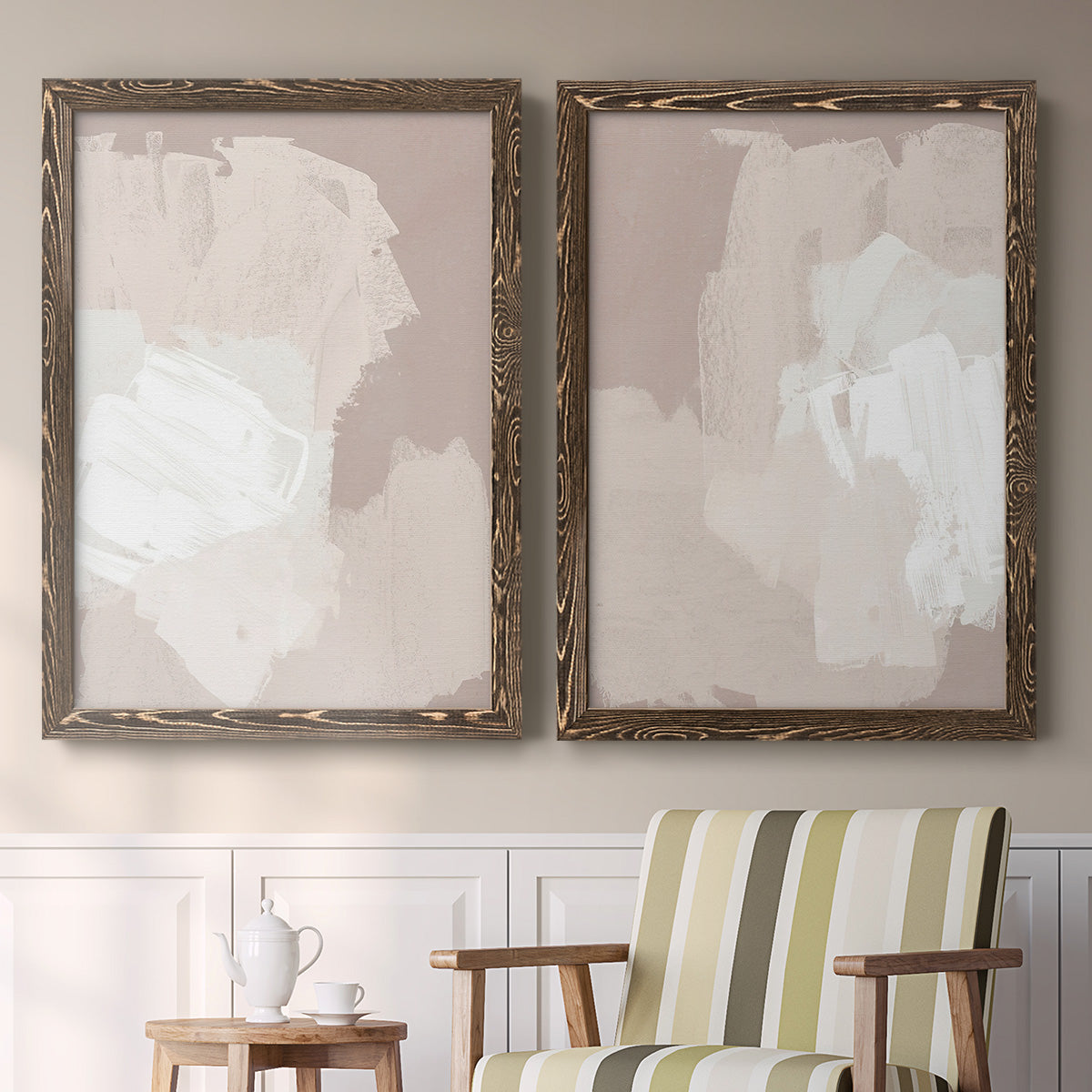 Set of two walnut barnwood framed canvas prints depicting two neutral minimalist abstracts featuring soft taupe blush and white paint blocks above a sideboard in a cozy sitting room.
