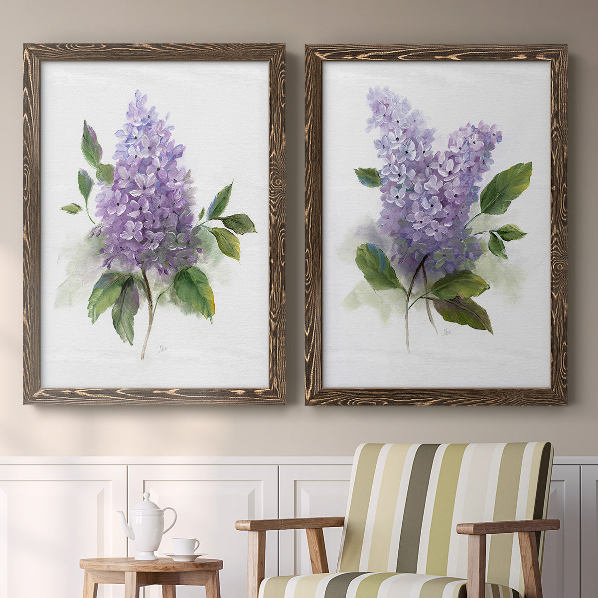 Set of two walnut barnwood framed canvas prints depicting two romantic traditional floral paintings featuring full purple lilac clusters with green leaves above a sideboard in a cozy sitting room.
