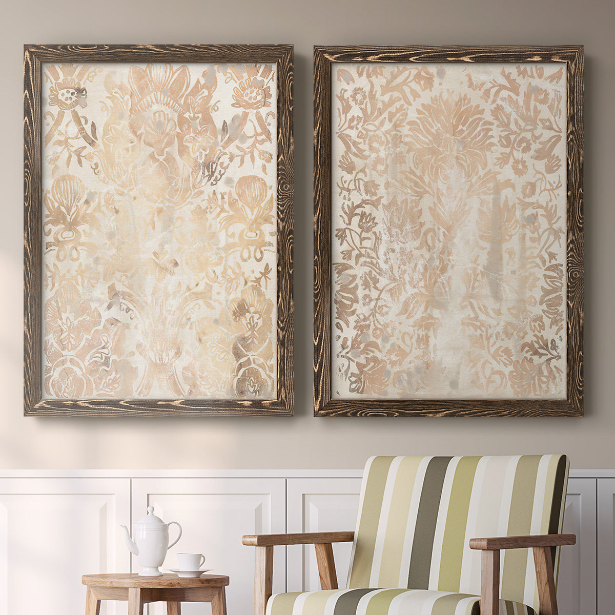 Set of two walnut barnwood framed canvas prints depicting two vintage decorative prints featuring ornate cream floral damask patterns above a sideboard in a cozy sitting room.
