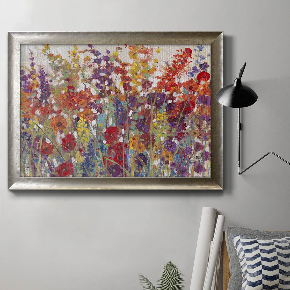 Impressionist floral bouquet artwork in an ornate mottled silver frame displayed in a neutral interior setting.