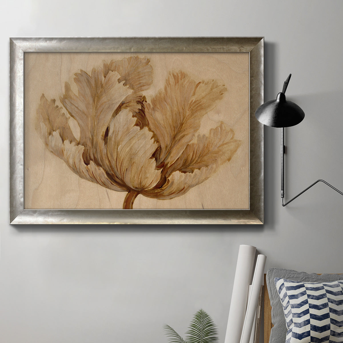 Minimalist sepia tulip botanical artwork in an ornate mottled silver frame displayed in a neutral interior setting.