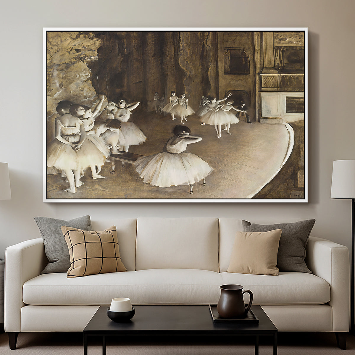 The Rehearsal of the Ballet Onstage, 1874 by Edgar Degas displayed in a white floater framed canvas above a sofa in a clean living room.