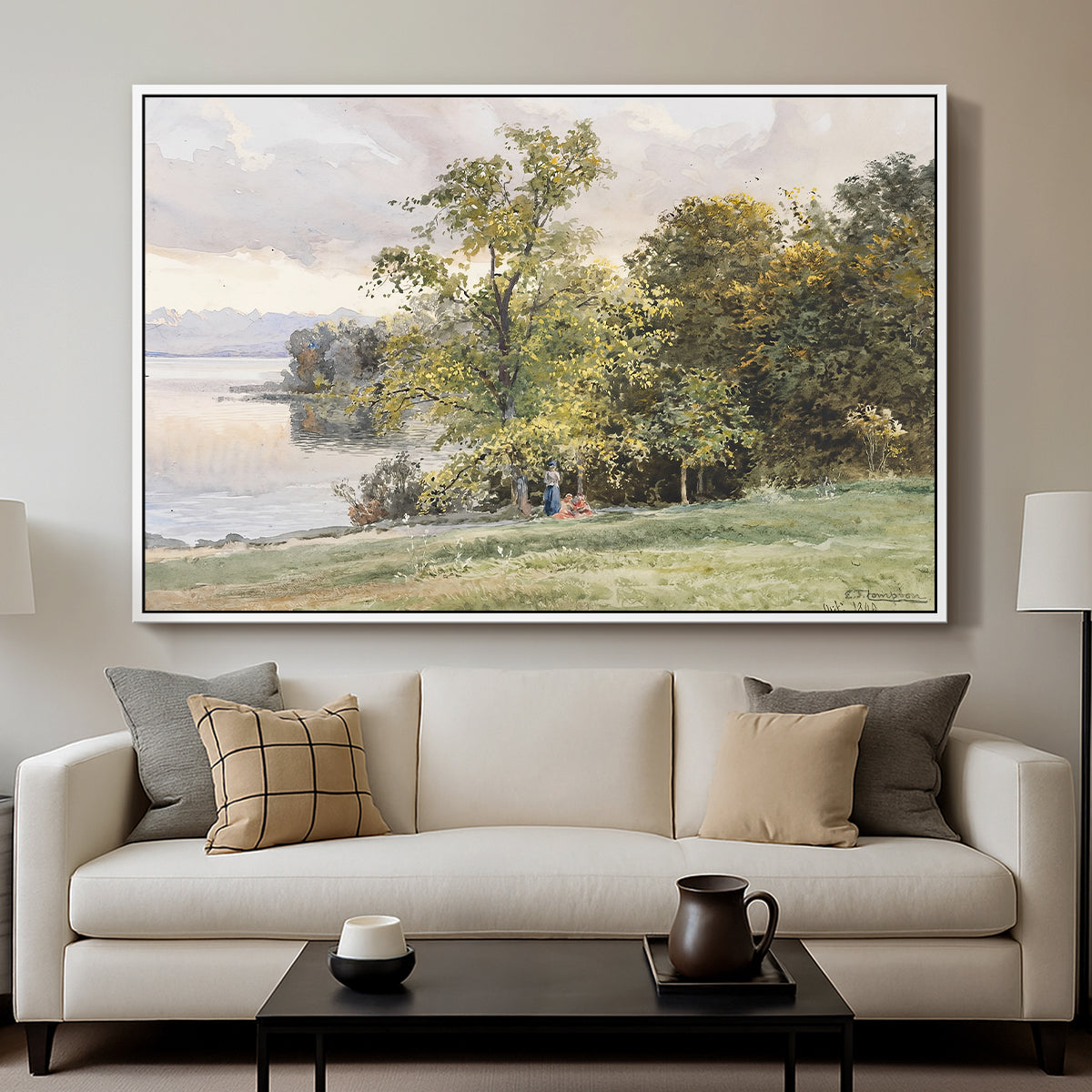 Landscape at Lake Starnberg, 1890 by Edward Theodore Compton displayed in a white floater framed canvas above a sofa in a clean living room.