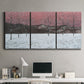 Three-panel canvas wall art featuring winter sunset snowfall landscape, displayed above a desk in a home office.