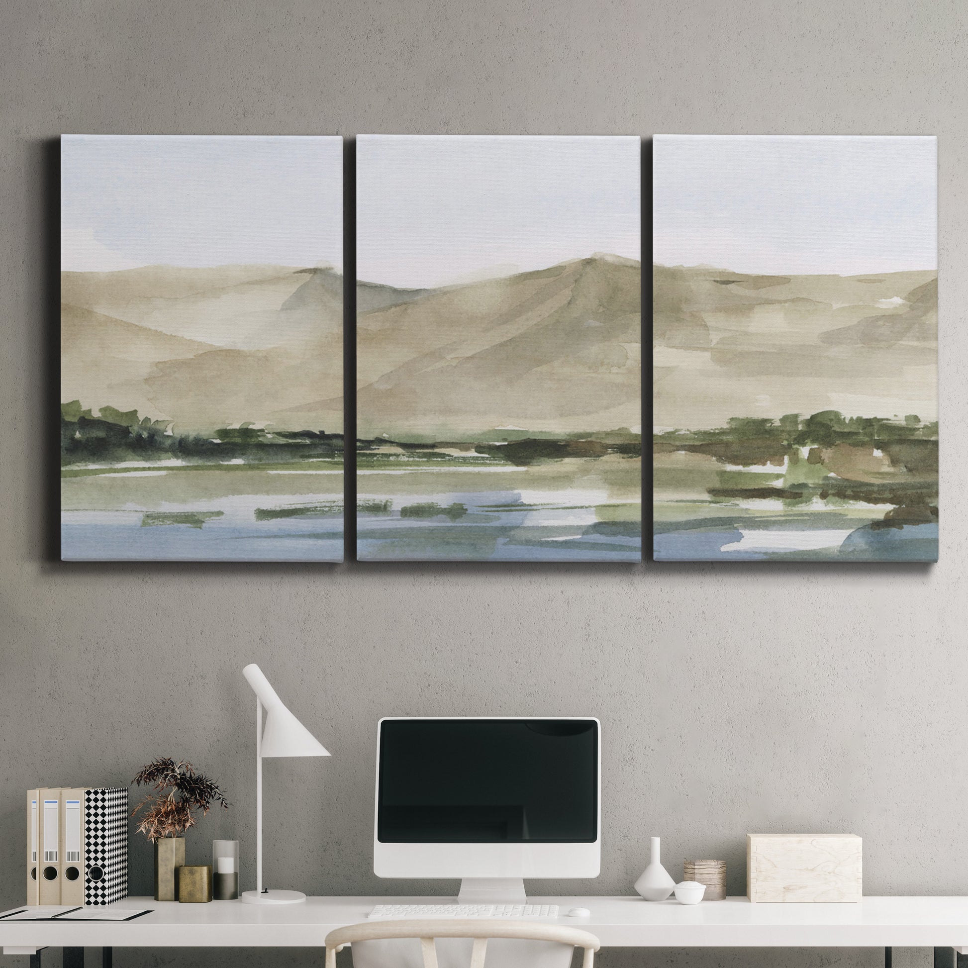 Three-panel canvas wall art featuring desert mountain landscape watercolor, displayed above a desk in a home office.