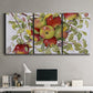 Three-panel canvas wall art featuring apples hanging from branch, displayed above a desk in a home office.