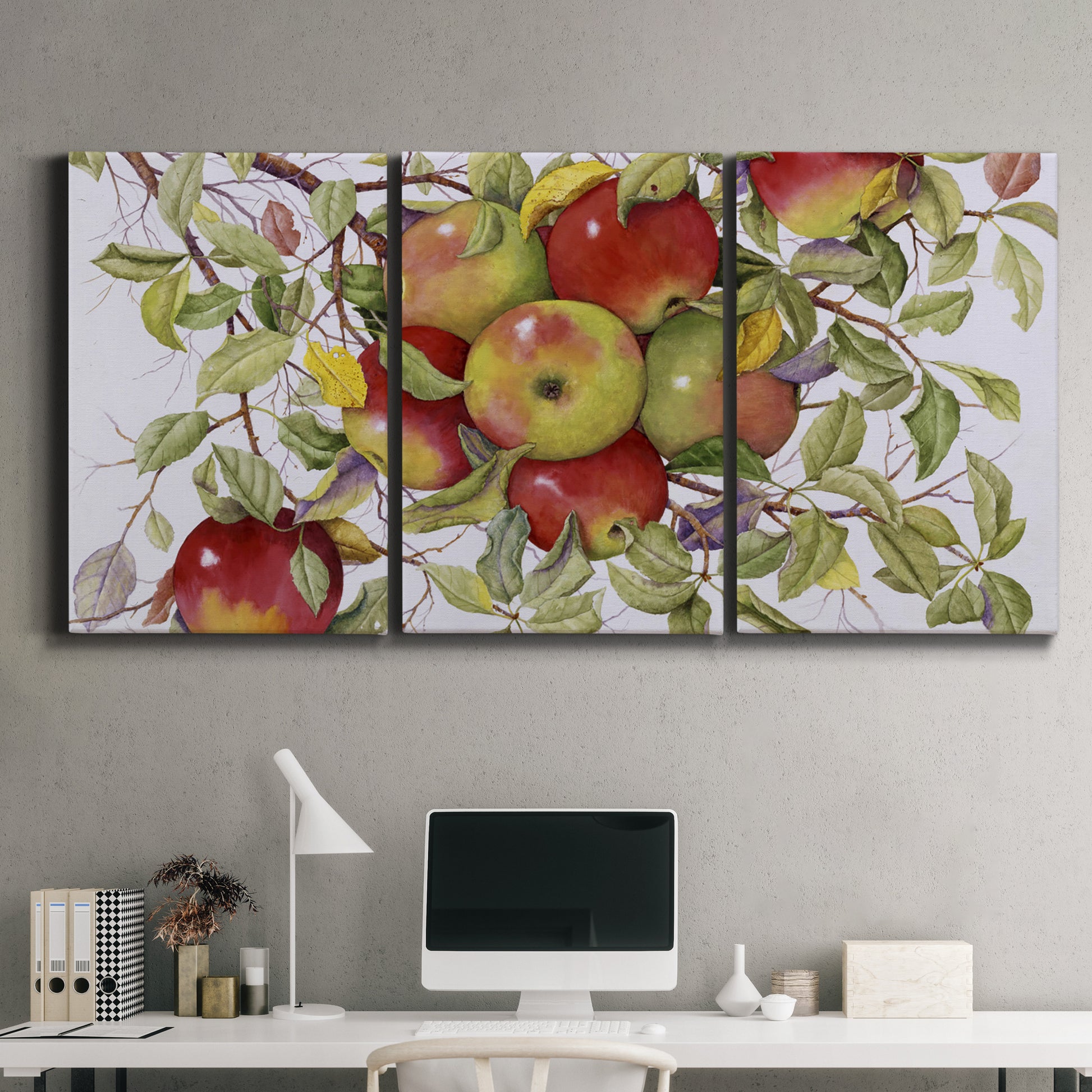 Three-panel canvas wall art featuring apples hanging from branch, displayed above a desk in a home office.
