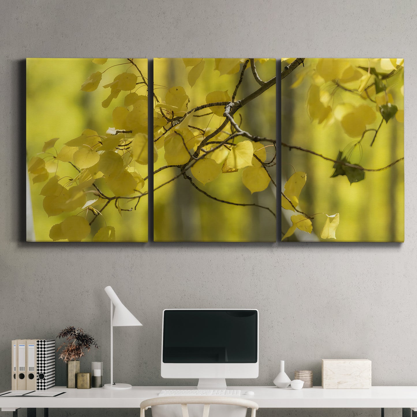 Three-panel canvas wall art featuring backlit aspen trees photograph, displayed above a desk in a home office.