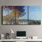 Three-panel canvas wall art featuring autumn poplar trees along river, displayed above a desk in a home office.