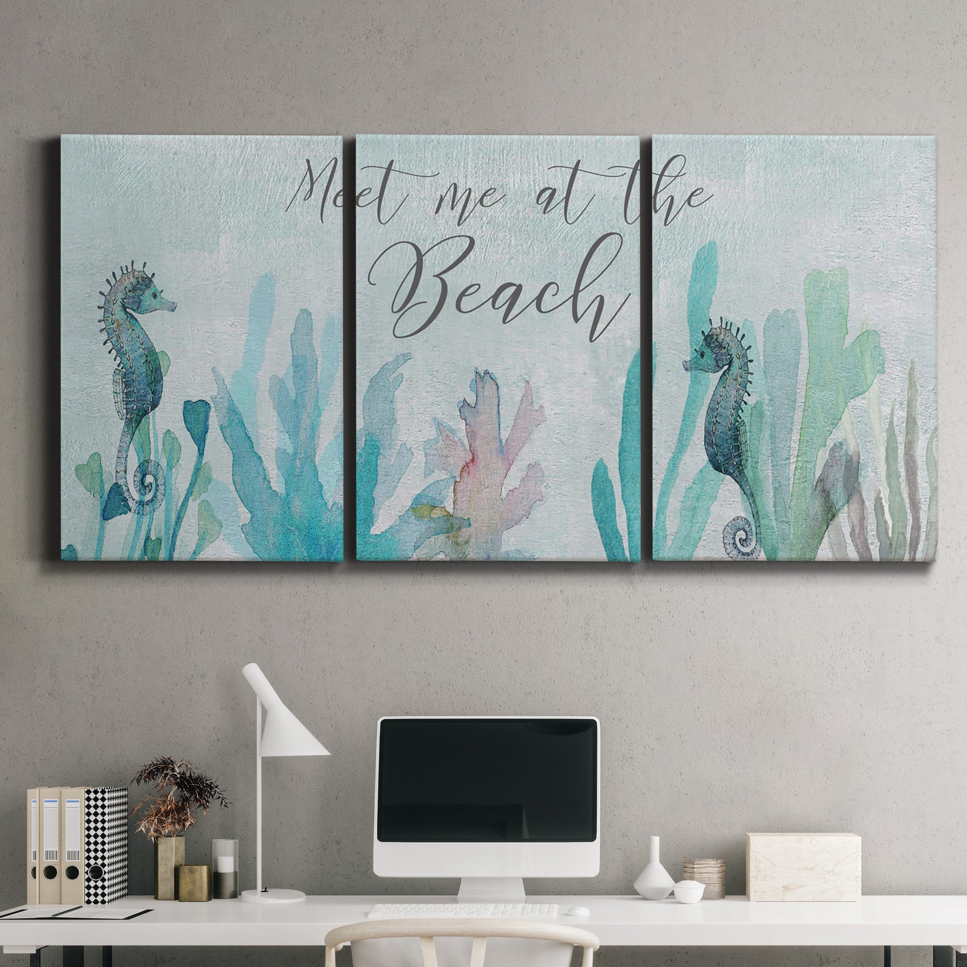 Three-panel canvas wall art featuring coastal typography with seahorses, displayed above a desk in a home office.