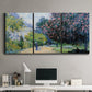 Three-panel canvas wall art featuring formal city park with trees, displayed above a desk in a home office.