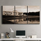 Three-panel canvas wall art featuring monochrome historic pavilion photograph, displayed above a desk in a home office.