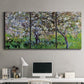 Three-panel canvas wall art featuring apple trees blooming beside water, displayed above a desk in a home office.