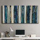 Three-panel canvas wall art featuring vertical blue abstract streaks, displayed above a desk in a home office.