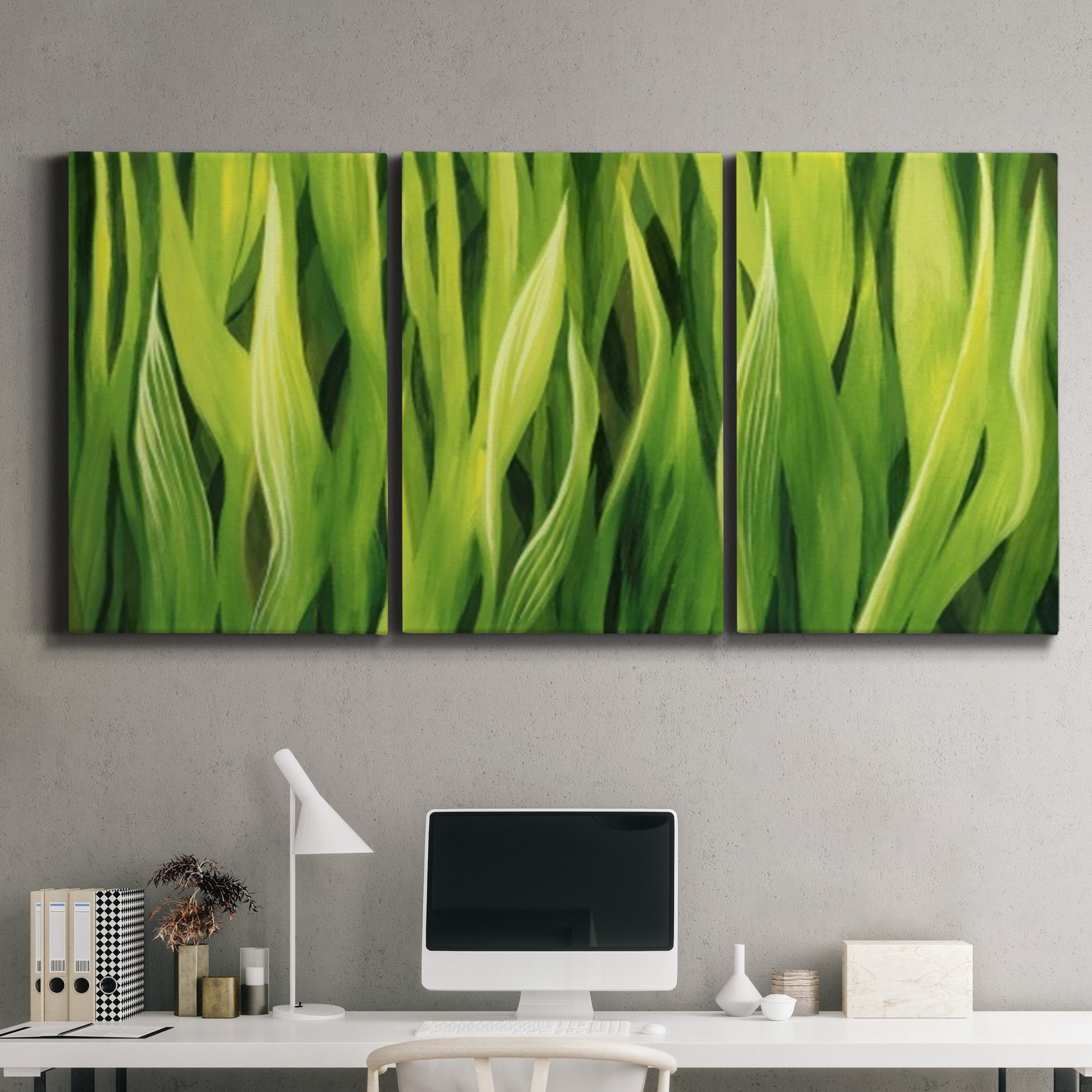 Three-panel canvas wall art featuring close view of tall green grass blades, displayed above a desk in a home office.