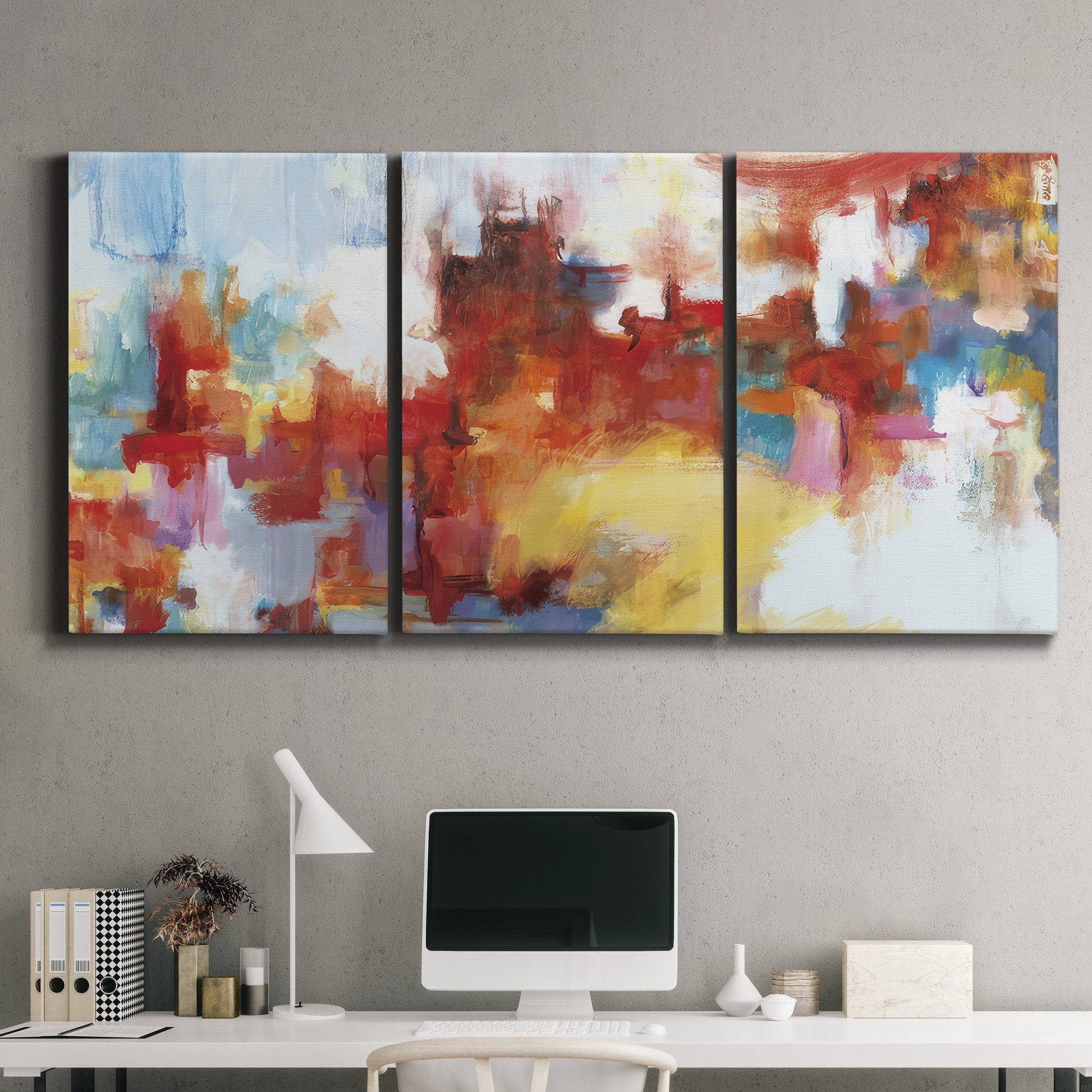 Three-panel canvas wall art featuring abstract city lights composition, displayed above a desk in a home office.
