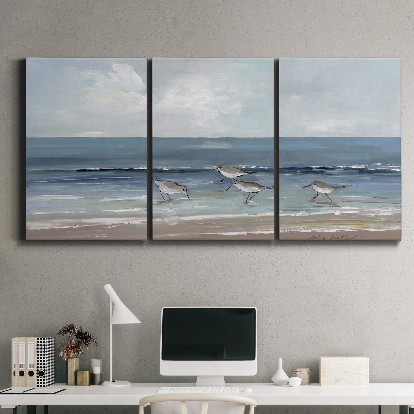 Three-panel canvas wall art featuring shore birds searching along beach, displayed above a desk in a home office.