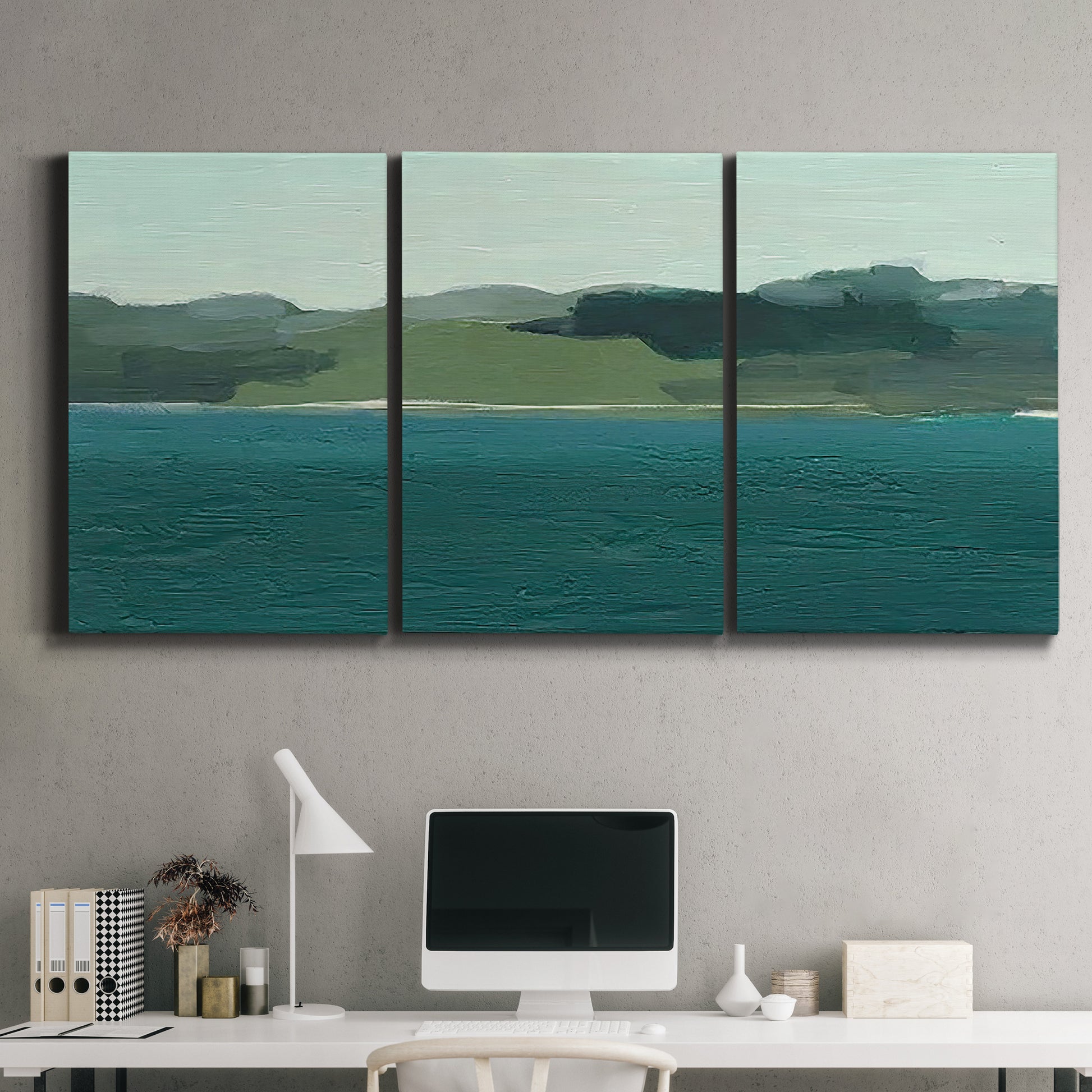 Three-panel canvas wall art featuring calm lake water under open sky, displayed above a desk in a home office.