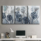 Three-panel canvas wall art featuring indigo floral abstraction, displayed above a desk in a home office.