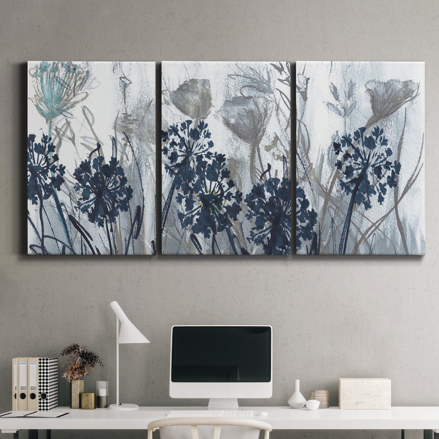 Three-panel canvas wall art featuring indigo floral abstraction, displayed above a desk in a home office.