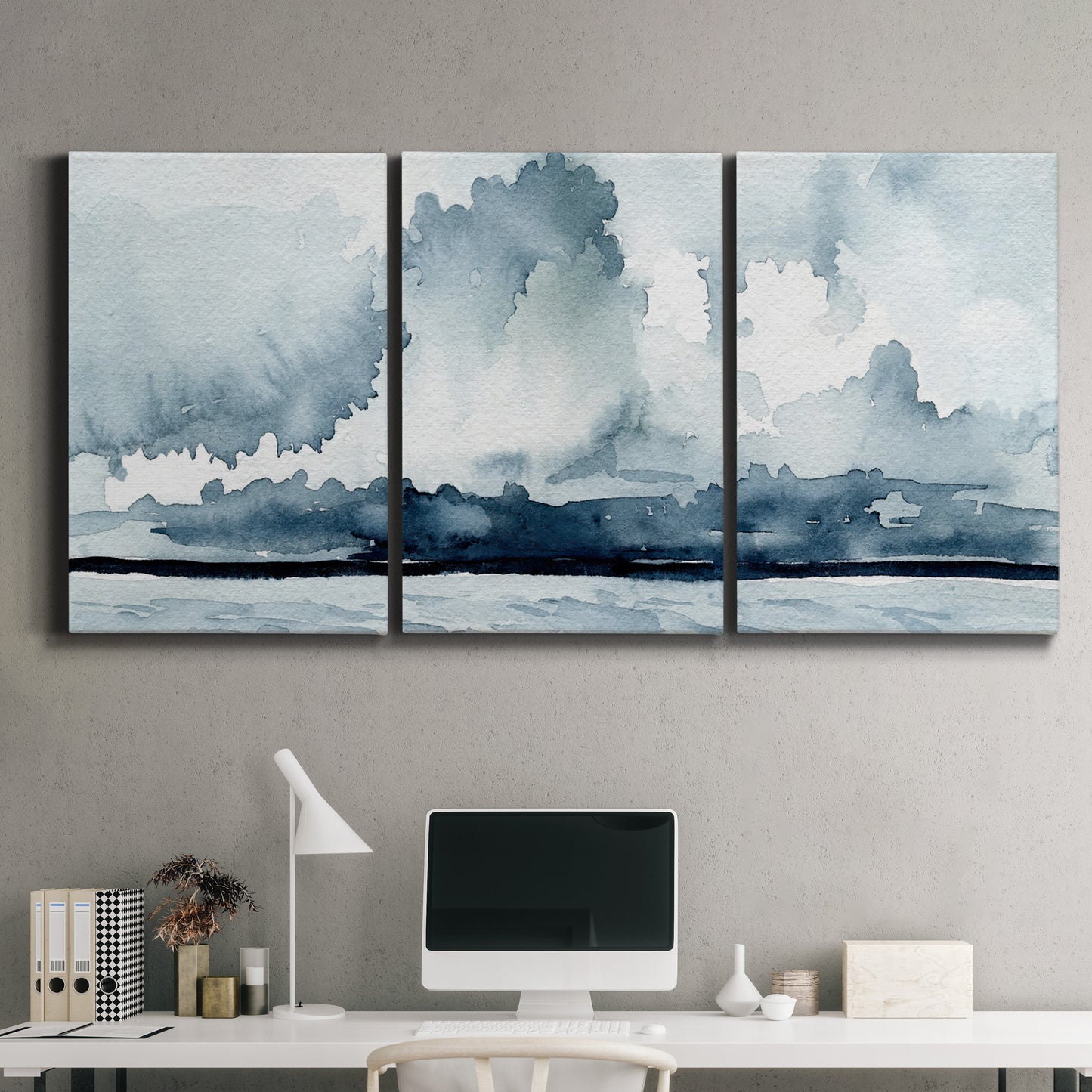 Three-panel canvas wall art featuring abstract rainstorm watercolor, displayed above a desk in a home office.