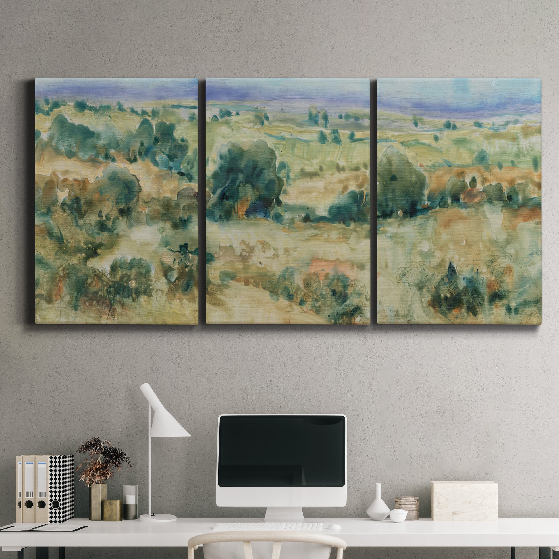 Three-panel canvas wall art featuring lavender sky over quiet landscape, displayed above a desk in a home office.