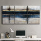 Three-panel canvas wall art featuring abstract blue urban composition, displayed above a desk in a home office.
