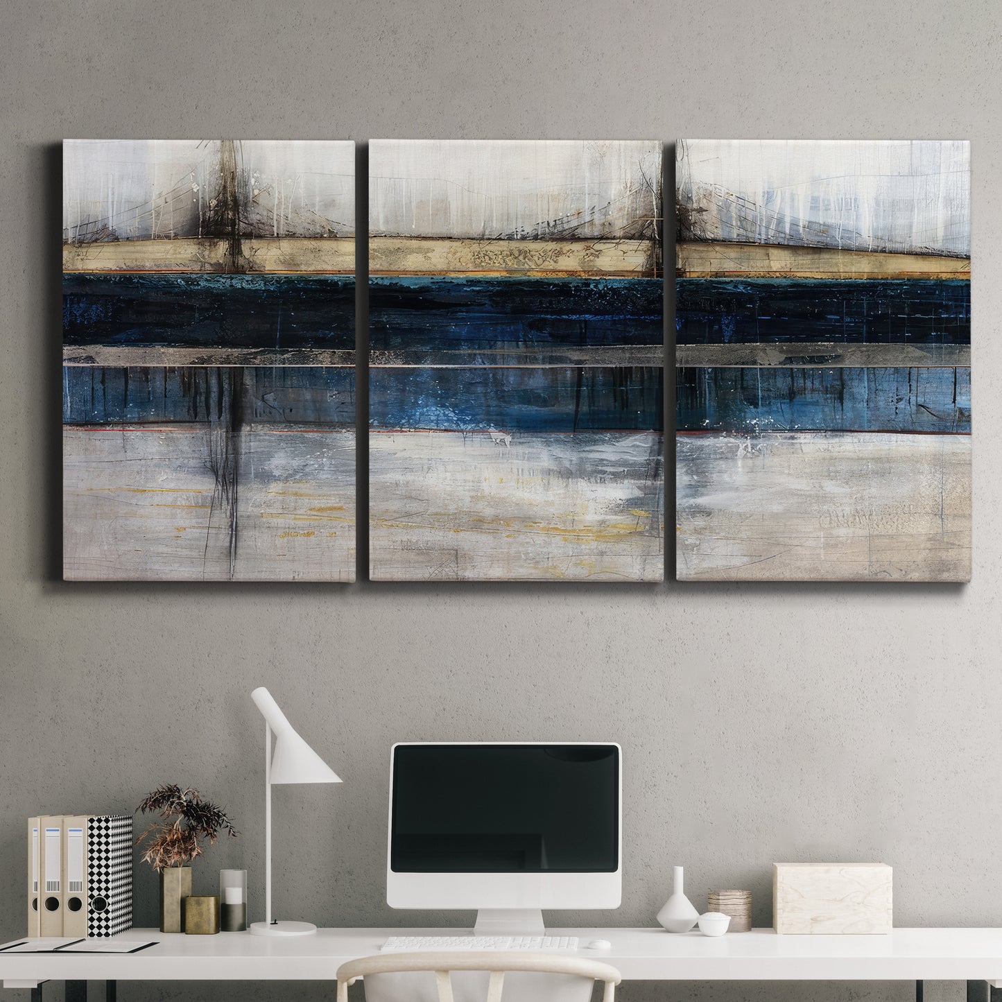 Three-panel canvas wall art featuring abstract blue urban composition, displayed above a desk in a home office.
