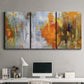 Three-panel canvas wall art featuring abstract warm sunset tones, displayed above a desk in a home office.