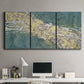 Three-panel canvas wall art featuring soft abstract wind movement, displayed above a desk in a home office.