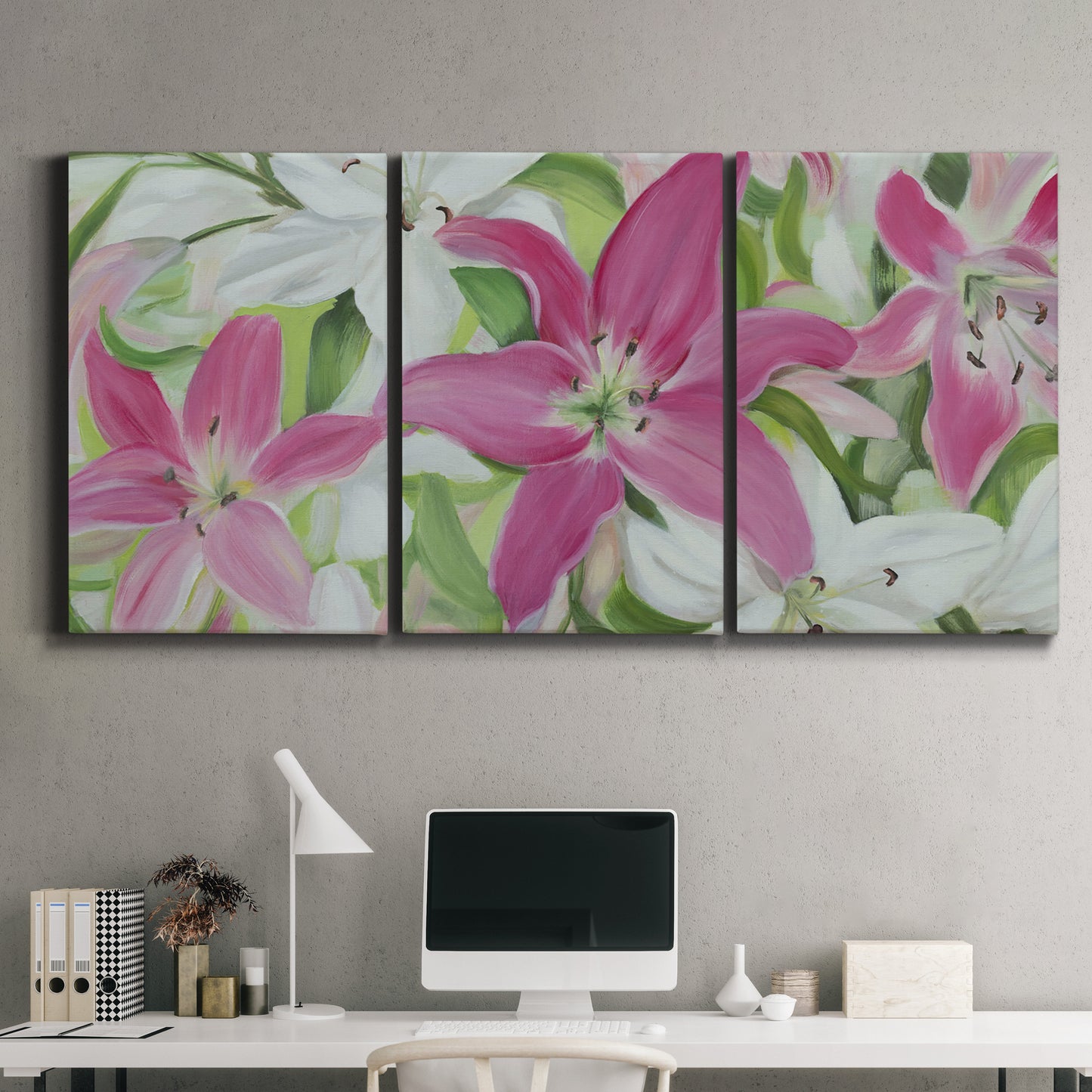 Three-panel canvas wall art featuring pink and white lilies in bloom, displayed above a desk in a home office.