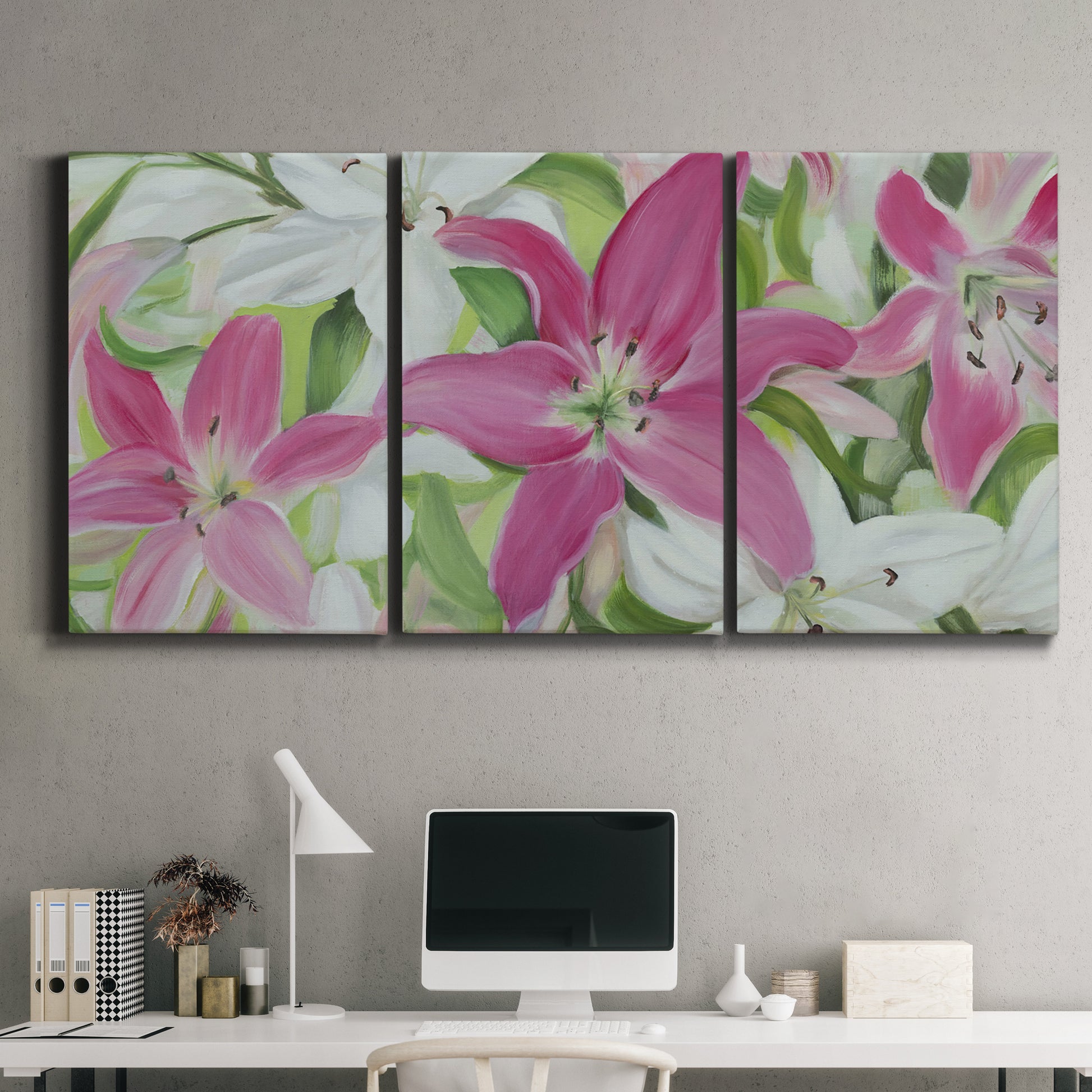 Three-panel canvas wall art featuring pink and white lilies in bloom, displayed above a desk in a home office.