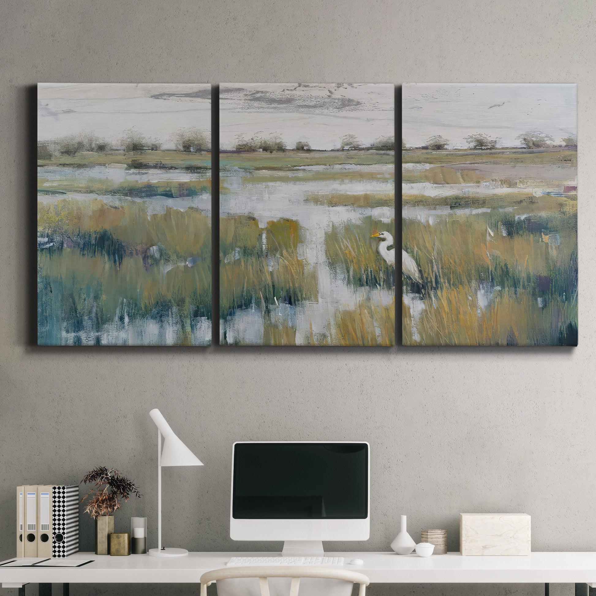 Three-panel canvas wall art featuring pastoral marshland landscape, displayed above a desk in a home office.