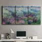 Three-panel canvas wall art featuring flowered riverbank with trees, displayed above a desk in a home office.
