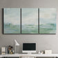 Three-panel canvas wall art featuring soft abstract coastal tones, displayed above a desk in a home office.