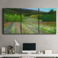 Three-panel canvas wall art featuring fresh spring meadow landscape, displayed above a desk in a home office.